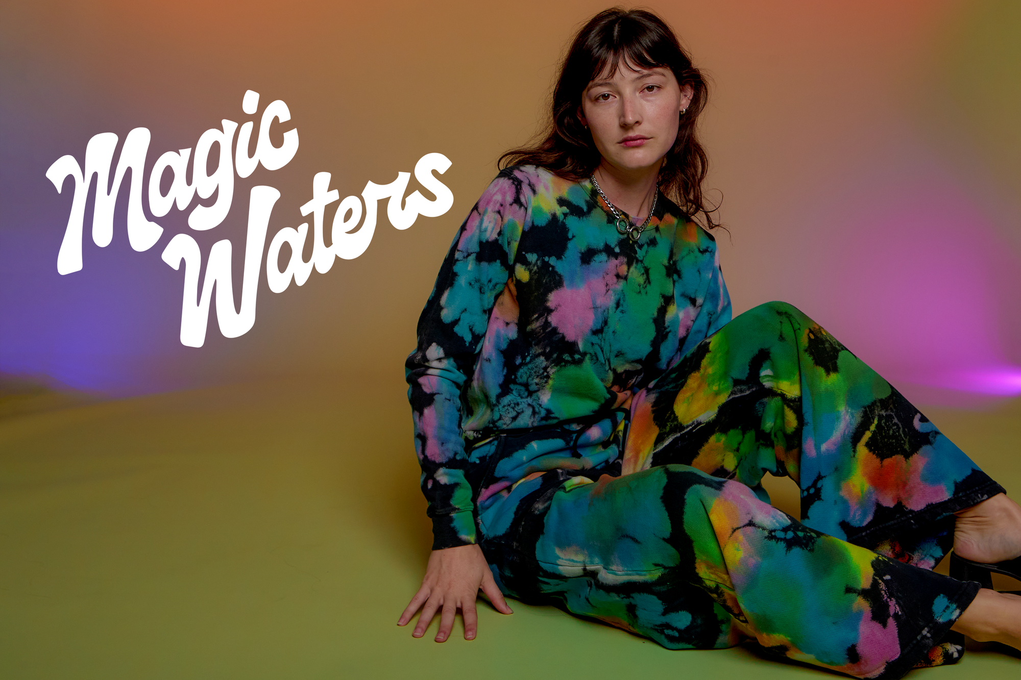 Alex is wearing an Oversized Hoodie in Rainbow Magic Waters and matching Wide Leg Sweats