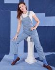 Alex is 5'8" and wearing P Indigo Denim Original Overalls in Light Wash with a vintage off-white Baby Tee underneath