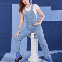 Alex is 5'8" and wearing P Indigo Denim Original Overalls in Light Wash with a vintage off-white Baby Tee underneath