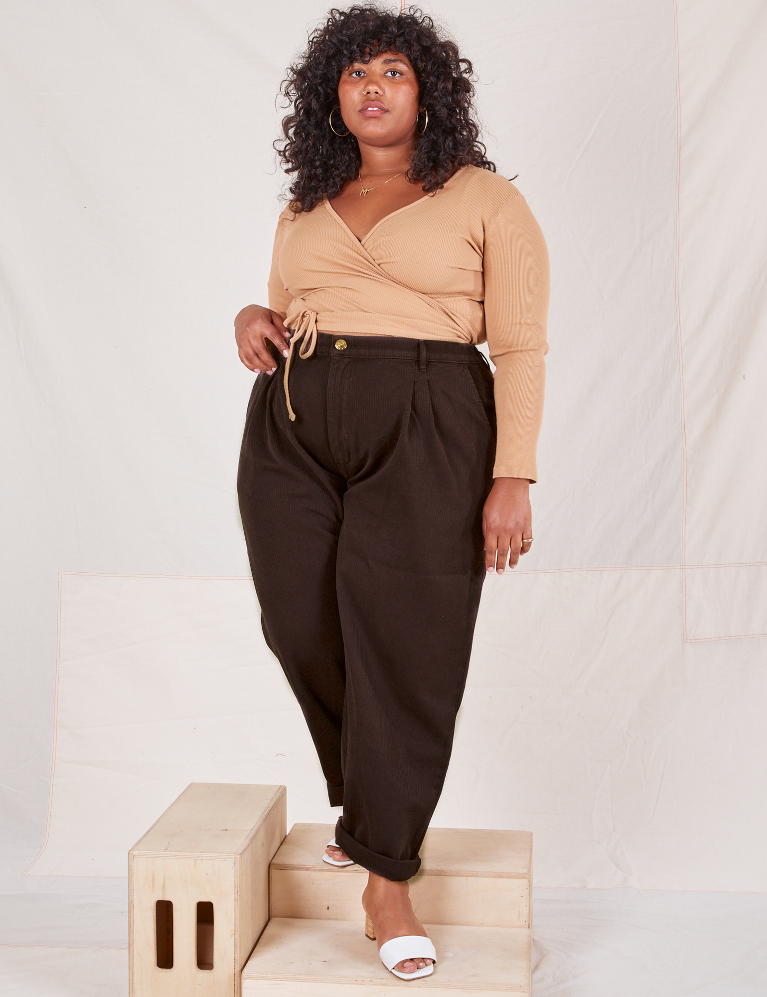 Morgan is 5&#39;5&quot; and wearing 1XL Heritage Trousers in Espresso Brown paired with tan Wrap Top