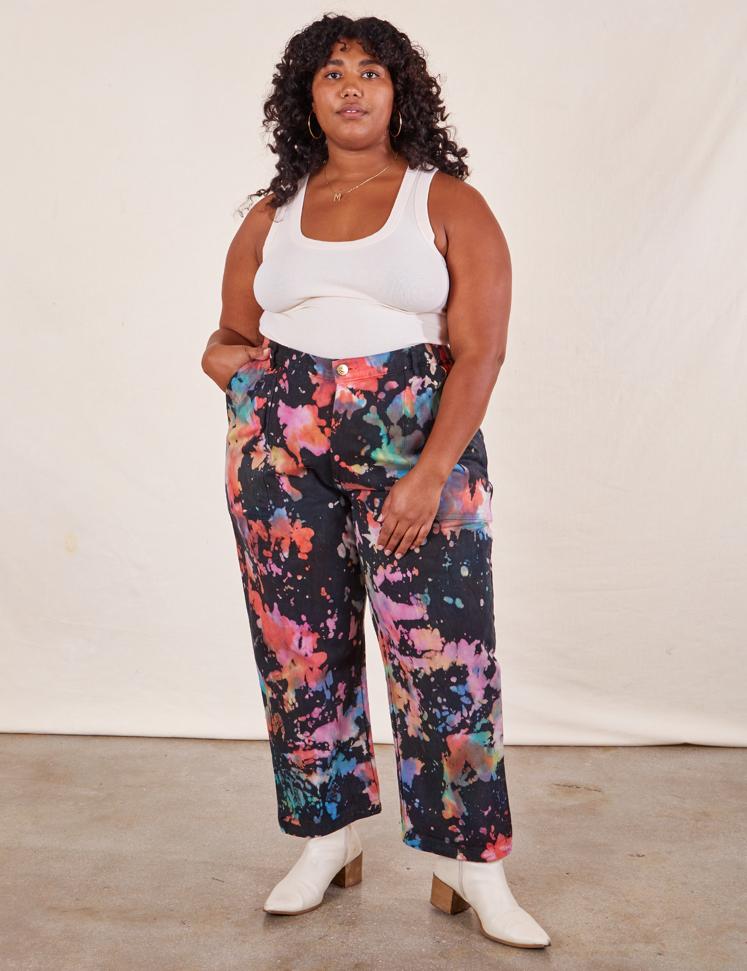 Morgan is 5&#39;5&quot; and wearing 1XL Rainbow Magic Waters Work Pants paired with vintage off-white Tank Top