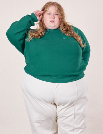 Catie is wearing 4XL Heavyweight Crew in Hunter Green paired with vintage off-white Western Pants