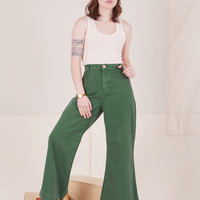 Hana is 5'3" and wearing XXS Bell Bottoms in Dark Emerald Green paired with vintage off-white Tank Top