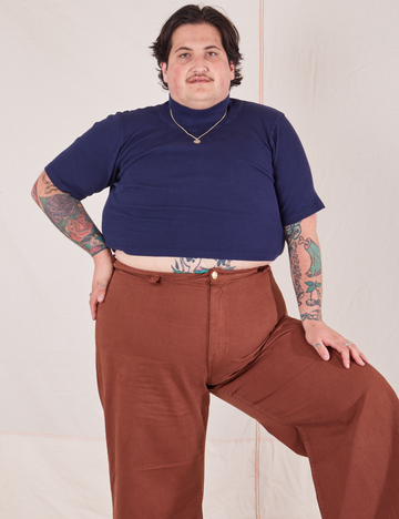 Sam is wearing size XL 1/2 Sleeve Essential Turtleneck in Navy Blue paired with fudgesicle brown Bell Bottoms