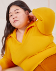 Ashley is wearing size L Long Sleeve Fisherman Polo in Sunshine Yellow