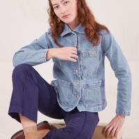 Alex is 5'8" and wearing XXS Indigo Denim Work Jacket in Light Wash paired with navy Western Pants