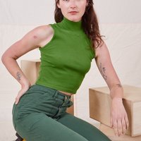 Alex is wearing P Sleeveless Essential Turtleneck in Bright Olive