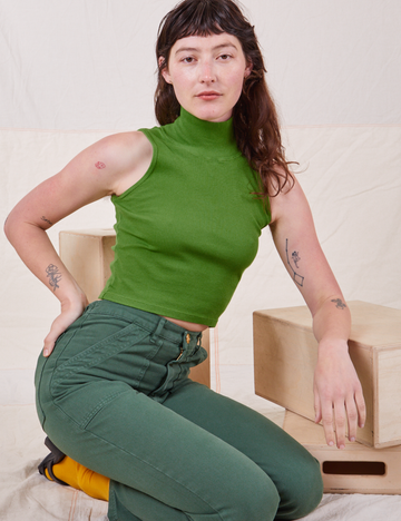 Alex is wearing P Sleeveless Essential Turtleneck in Bright Olive