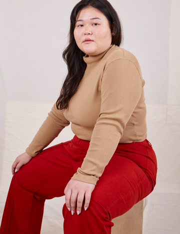Ashley is wearing L Essential Turtleneck in Tan