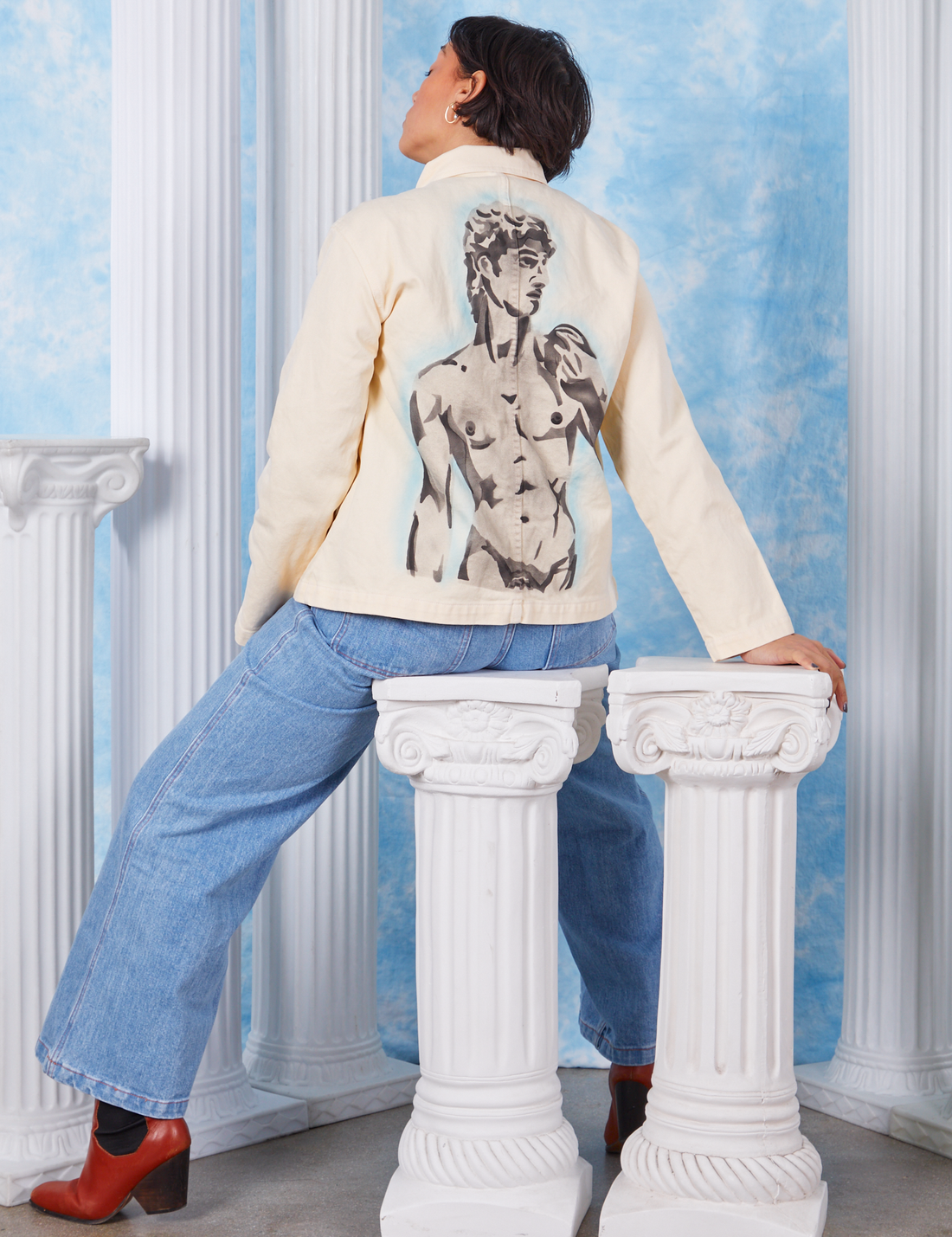 Tiara wearing XS Neoclassical Work Jacket featuring airbrushed David statue on back of jacket