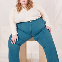 Catie is wearing Organic Work Pants in Marine Blue and vintage off-white Long Sleeve Fisherman Polo