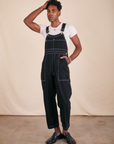 Jerrod is 6'3" and wearing M Original Overalls in Basic Black paired with vintage off-white Baby Tee