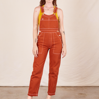 Alex is 5'8"and wearing P Original Overalls in Burnt Terracotta