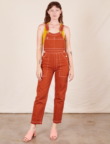 Alex is 5'8"and wearing P Original Overalls in Burnt Terracotta