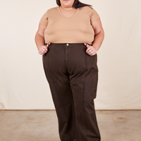 Sarita is 5'7" and wearing 3XL Western Pants in Espresso Brown paired with a tan V-Neck Tee