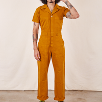 Jesse is 5'7" and wearing S Short Sleeve Jumpsuit in Spicy Mustard