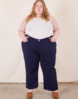 Catie is 5'11" and wearing 5XL Western Pants in Navy Blue paired with vintage off-white Tank Top