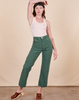Alex is 5'8" and wearing XS Work Pants in Dark Emerald Green paired with vintage off-white Tank Top