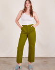 Allison is 5'10" and wearing S Work Pants in Olive Green paired with vintage off-white Tank Top