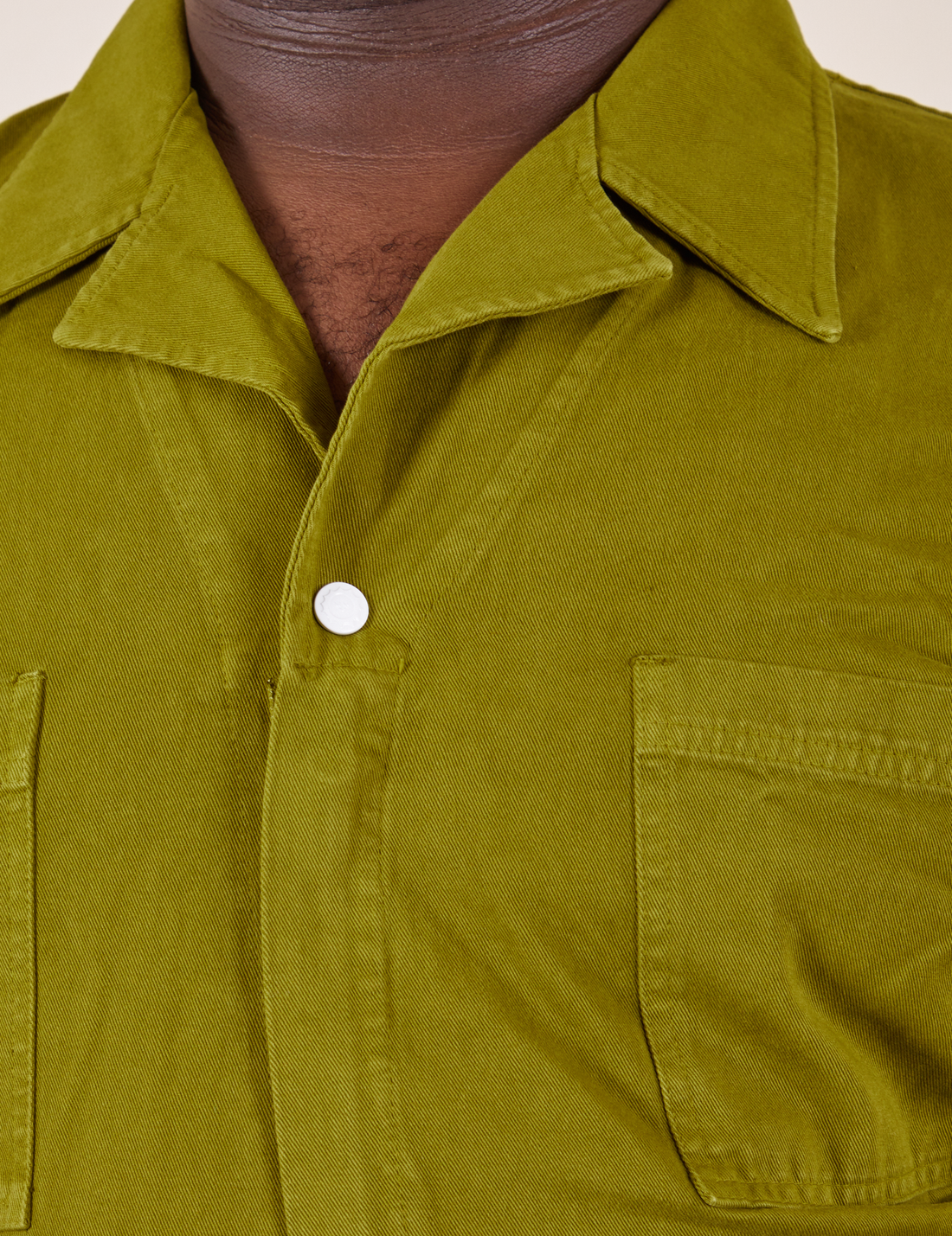 Front close up of Short Sleeve Jumpsuit in Olive Green worn by Elijah