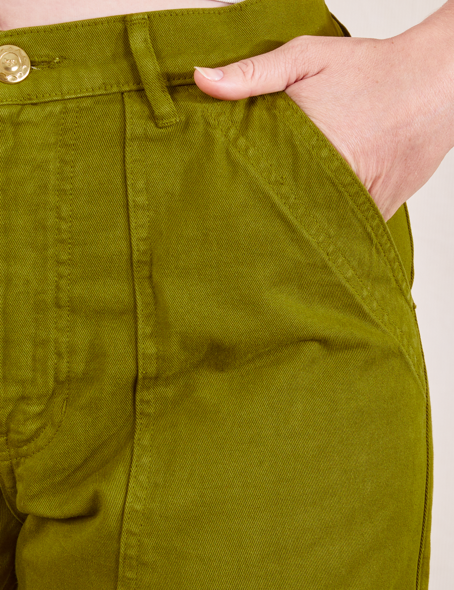 Work Pants in Olive Green front pocket close up on Allison with hand in pocket