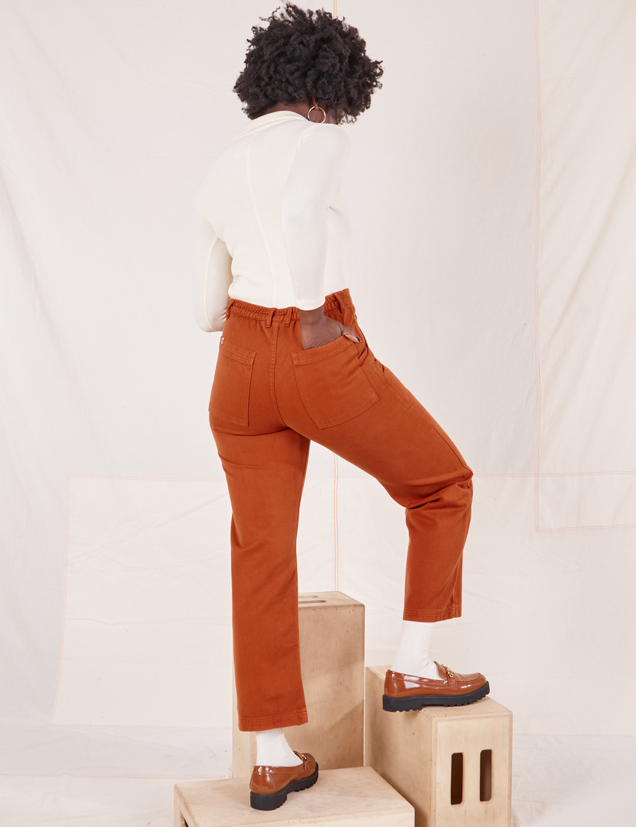 Organic Work Pants in Burnt Terracotta back view on Reece wearing vintage off-white Long Sleeve Fisherman Polo