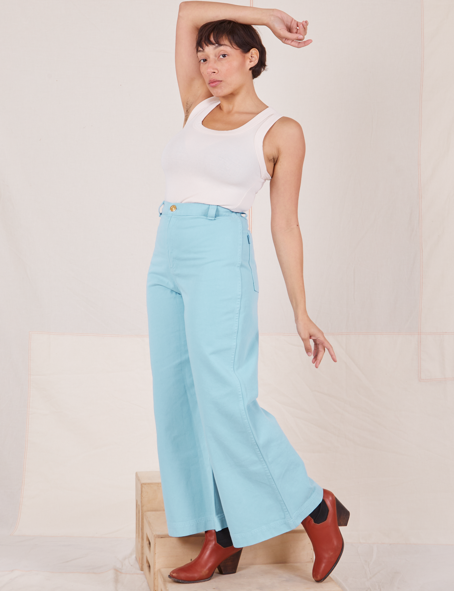 Tiara is wearing Bell Bottoms in Baby Blue and vintage off-white Tank Top