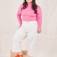 Ashley is wearing Essential Turtleneck in Bubblegum Pink and vintage off-white Western Pants
