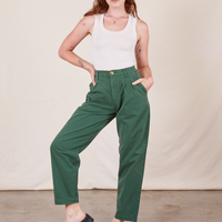 Alex is wearing Heavyweight Trousers in Dark Emerald Green and vintage off-white Tank Top