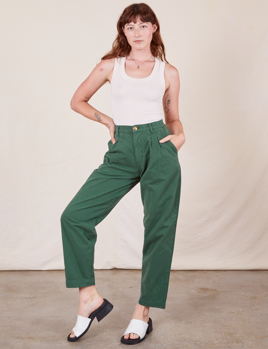 Alex is wearing Heavyweight Trousers in Dark Emerald Green and vintage off-white Tank Top