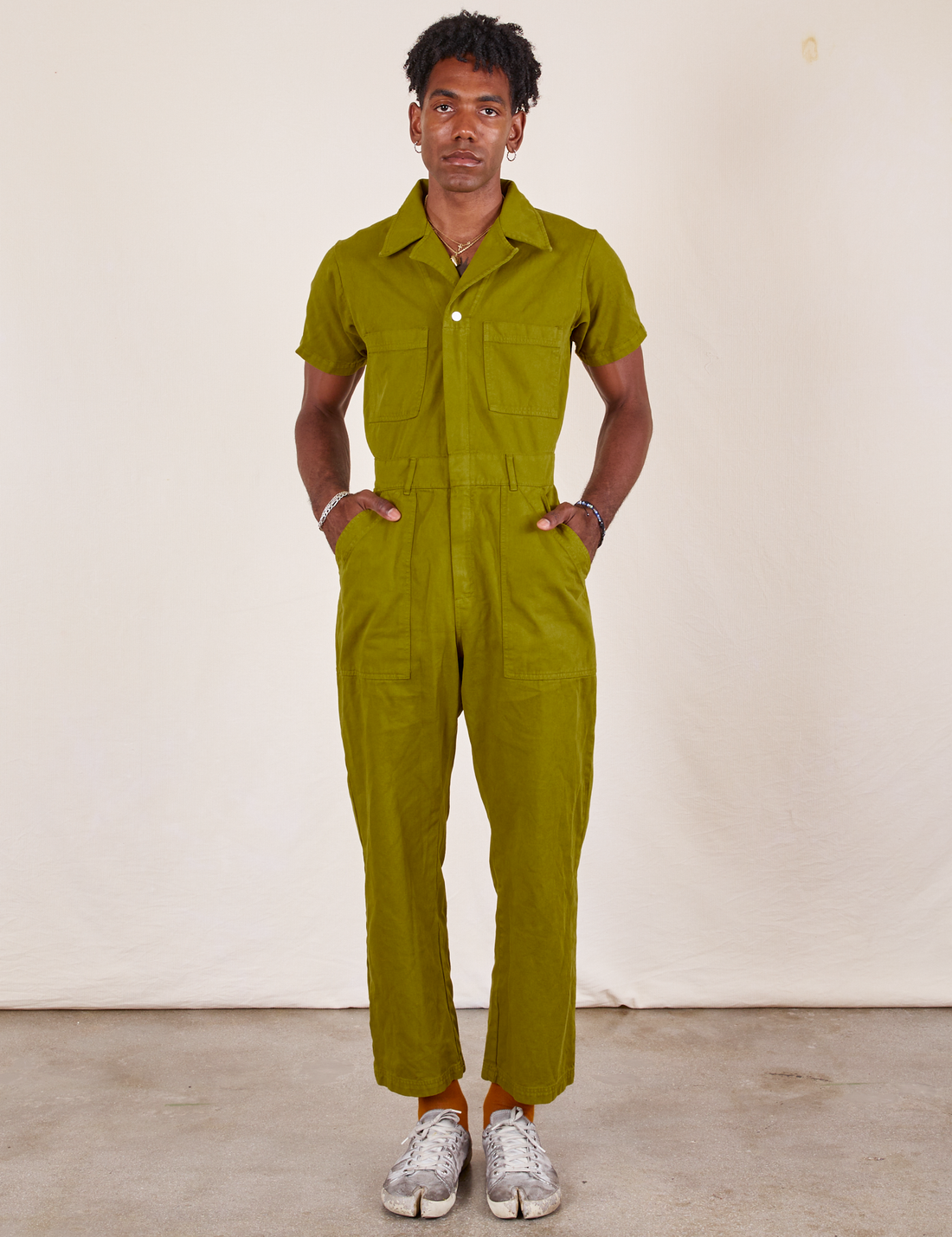 Jerrod is 6'3" and wearing L Short Sleeve Jumpsuit in Olive Green