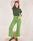 Alex is wearing Organic Vintage Tee in Dark Emerald Green and gross green Western Pants