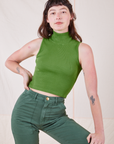 Alex is wearing Sleeveless Essential Turtleneck in Bright Olive