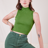 Alex is wearing Sleeveless Essential Turtleneck in Bright Olive
