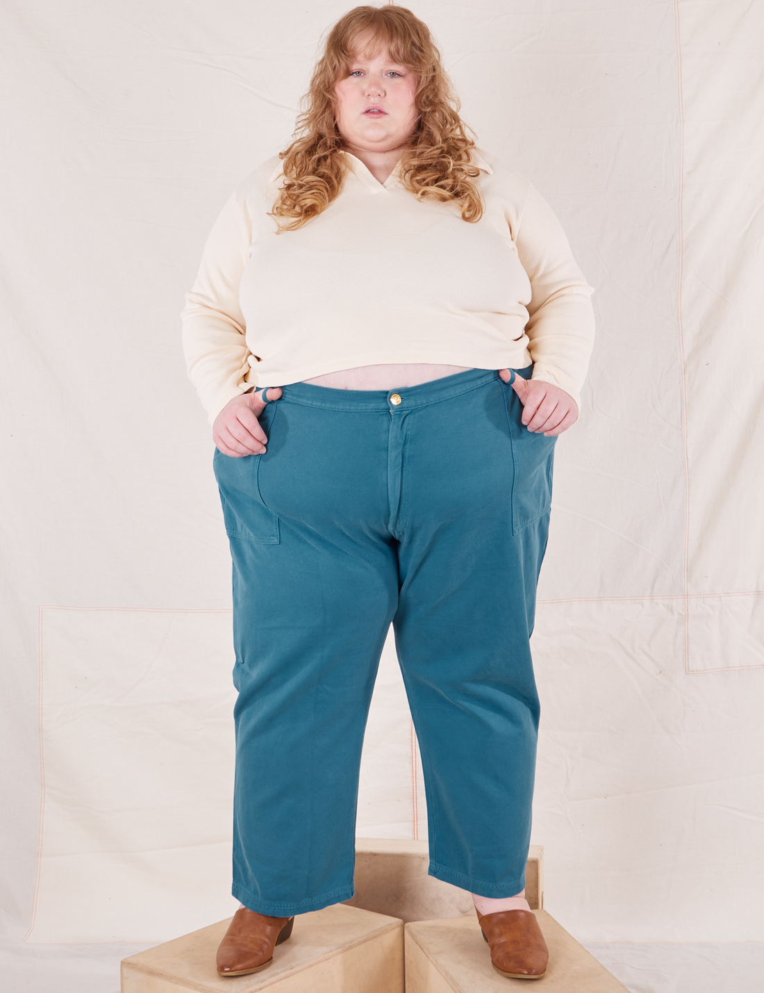 Catie is 5'11" and wearing 5XL Organic Work Pants in Marine Blue paired with vintage off-white Long Sleeve Fisherman Polo