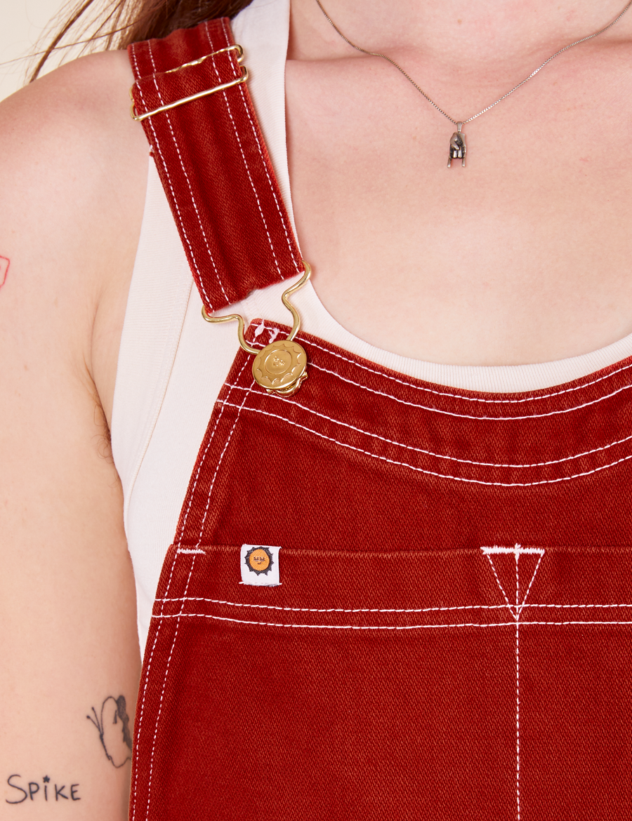 Original Overalls in Paprika front close up of white stitching and gold hardware on Alex
