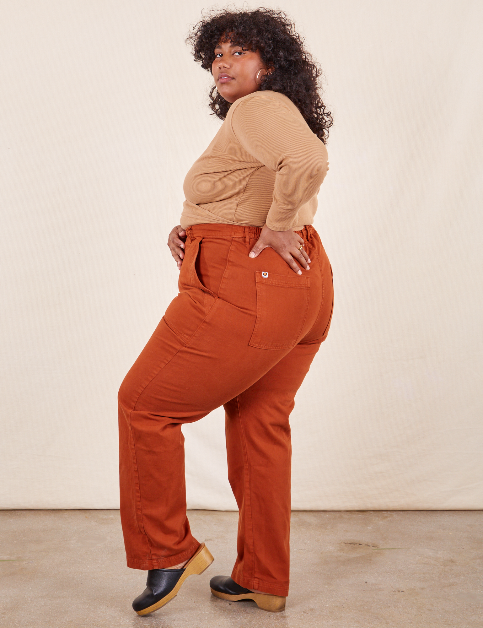 Side view of Work Pants in Burnt Terracotta and tan Wrap Top on Morgan