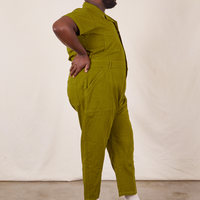 Side view of Short Sleeve Jumpsuit in Olive Green worn by Elijah