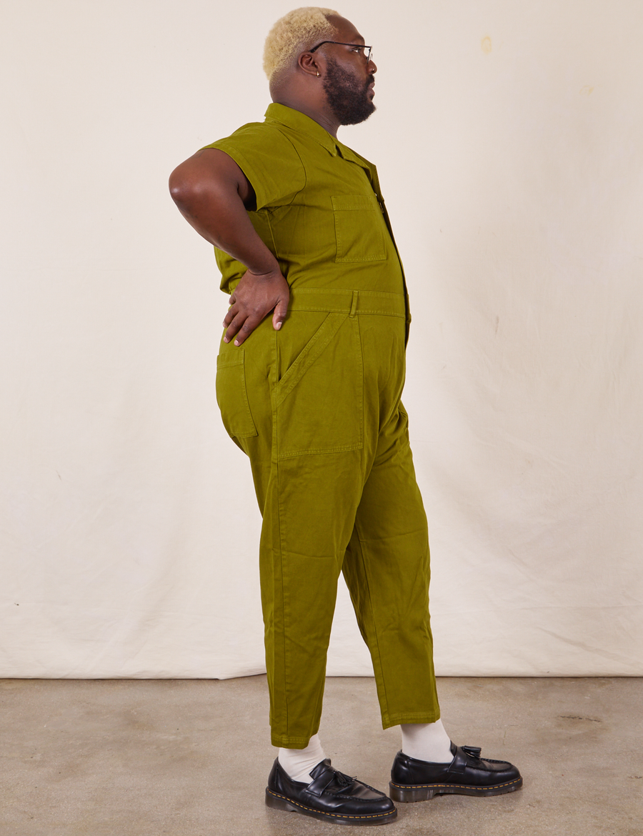 Side view of Short Sleeve Jumpsuit in Olive Green worn by Elijah