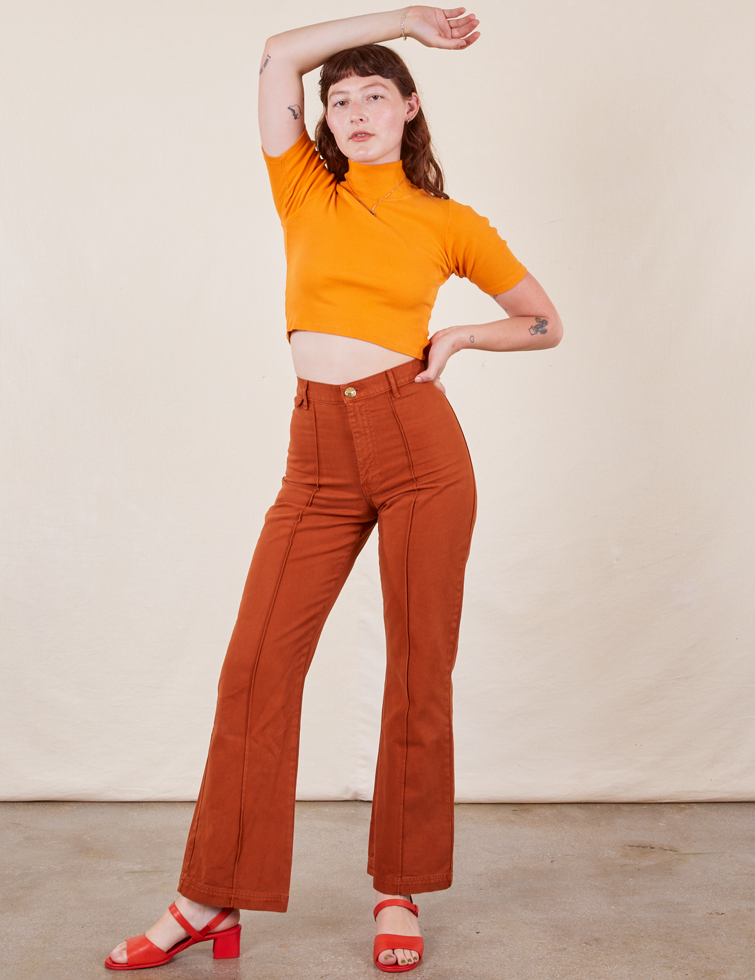 Western Pants in Burnt Terracotta on Alex wearing creamsicle orange 1/2 Sleeve Essential Turtleneck
