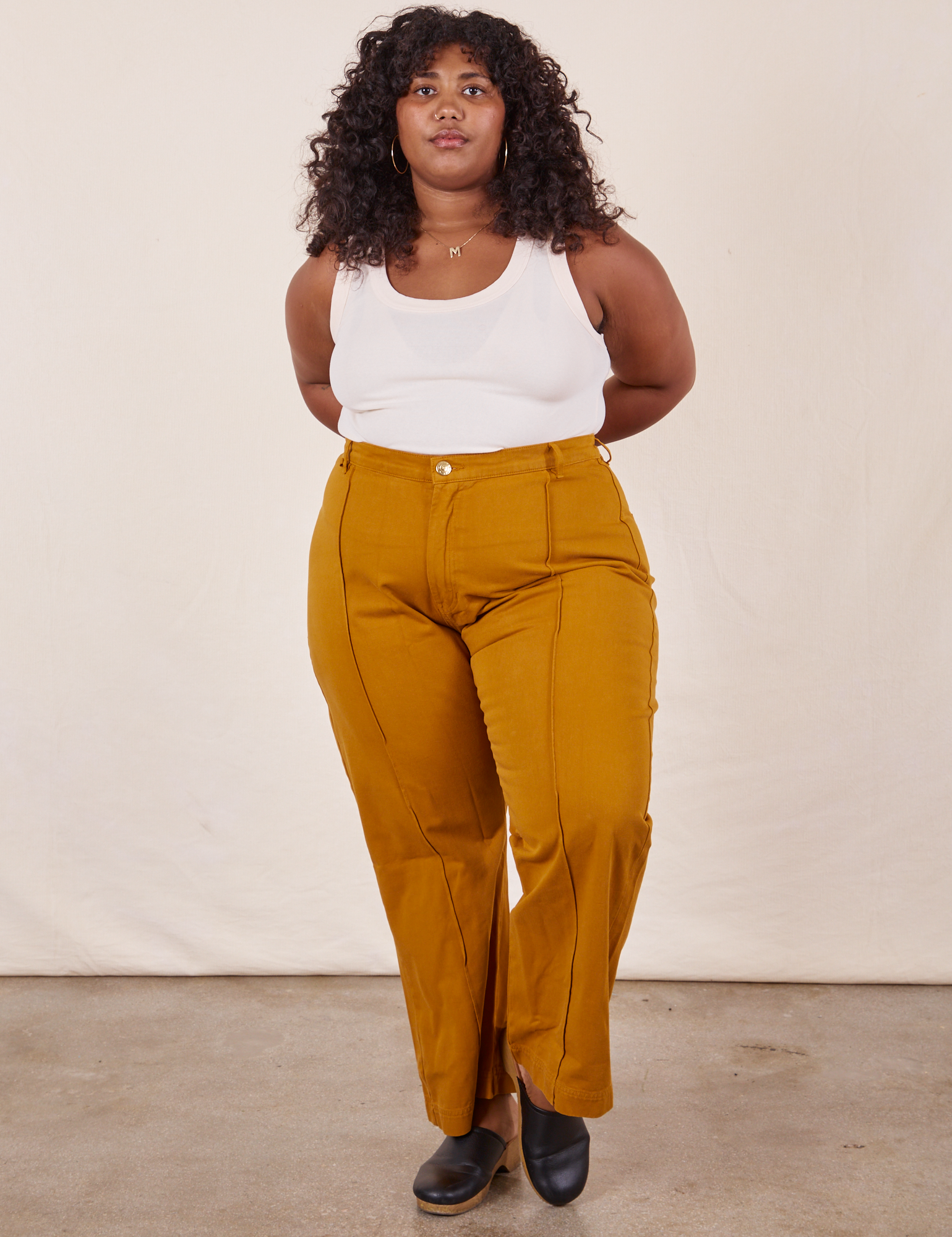 Morgan is wearing Western Pants in Spicy Mustard and vintage off-white Tank Top