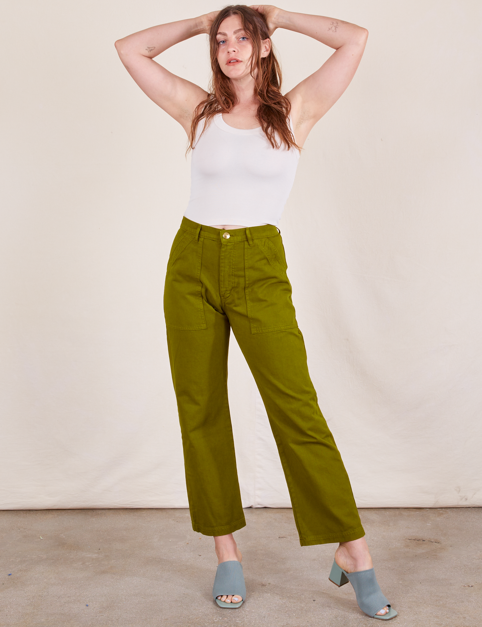 Allison is wearing Work Pants in Olive Green and vintage off-white Tank Top
