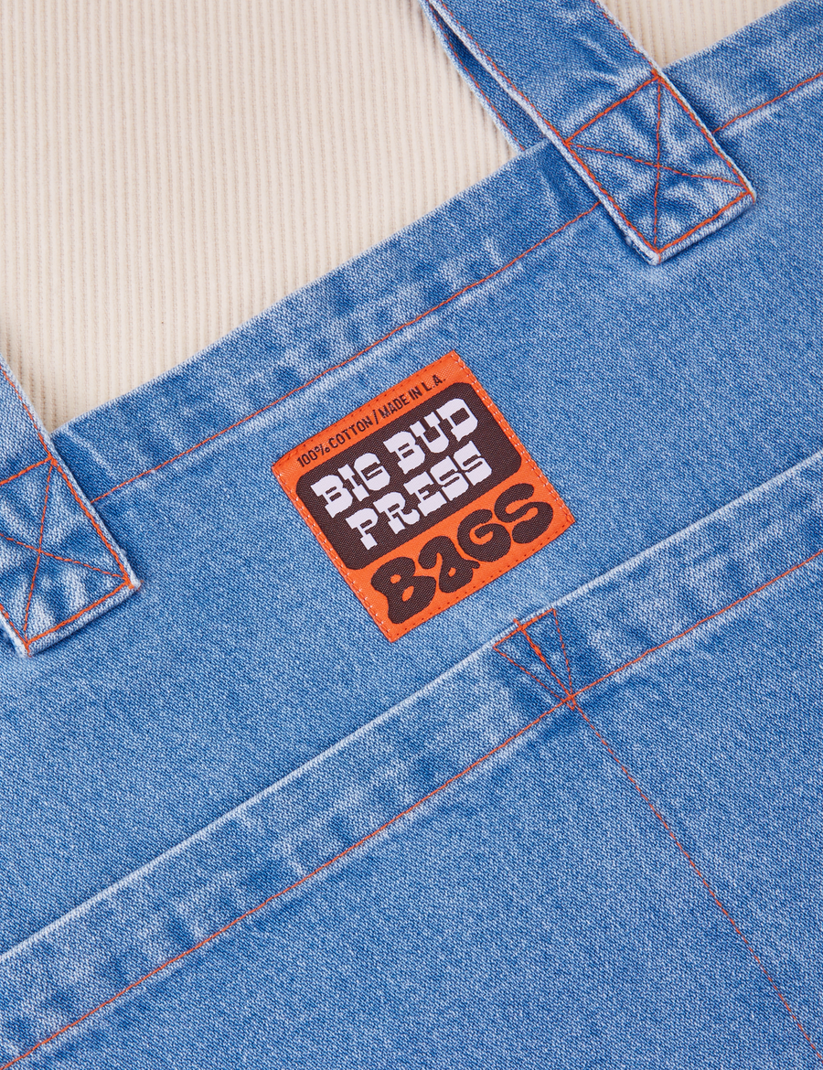 Denim Everyday Tote Bag in Light wash close up with brown and orange Big Bud Press label