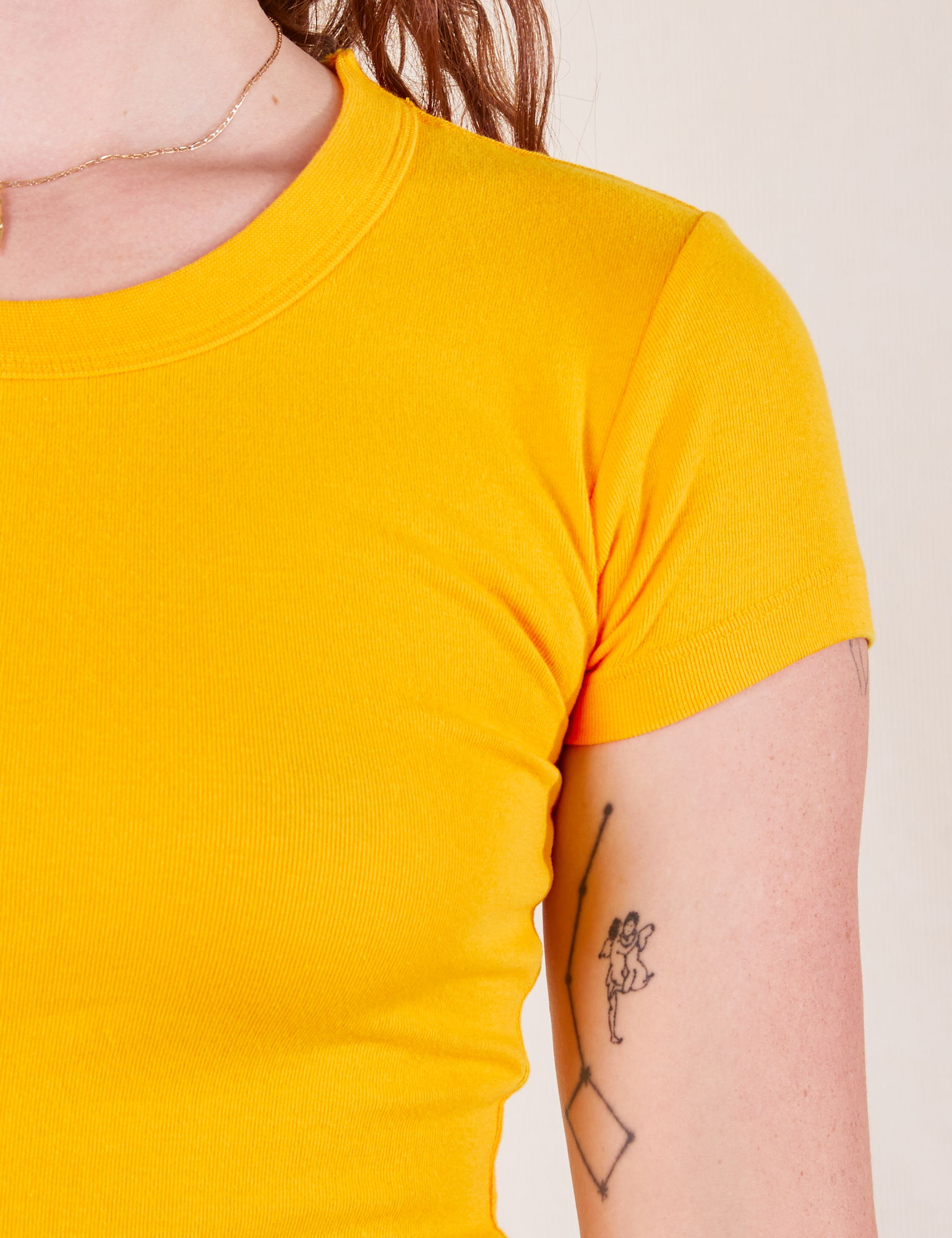 Front close up of Baby Tee in Sunshine Yellow on Alex