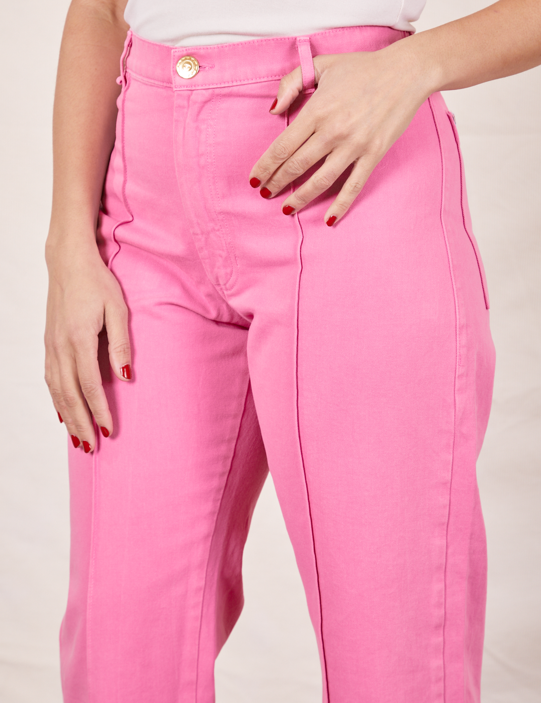 Western Pants in Bubblegum Pink front close up on Tiara with thumb through belt loop