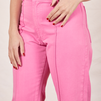 Western Pants in Bubblegum Pink front close up on Tiara with thumb through belt loop