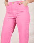 Work Pants in Bubblegum Pink close up on Tiara with hands in pockets