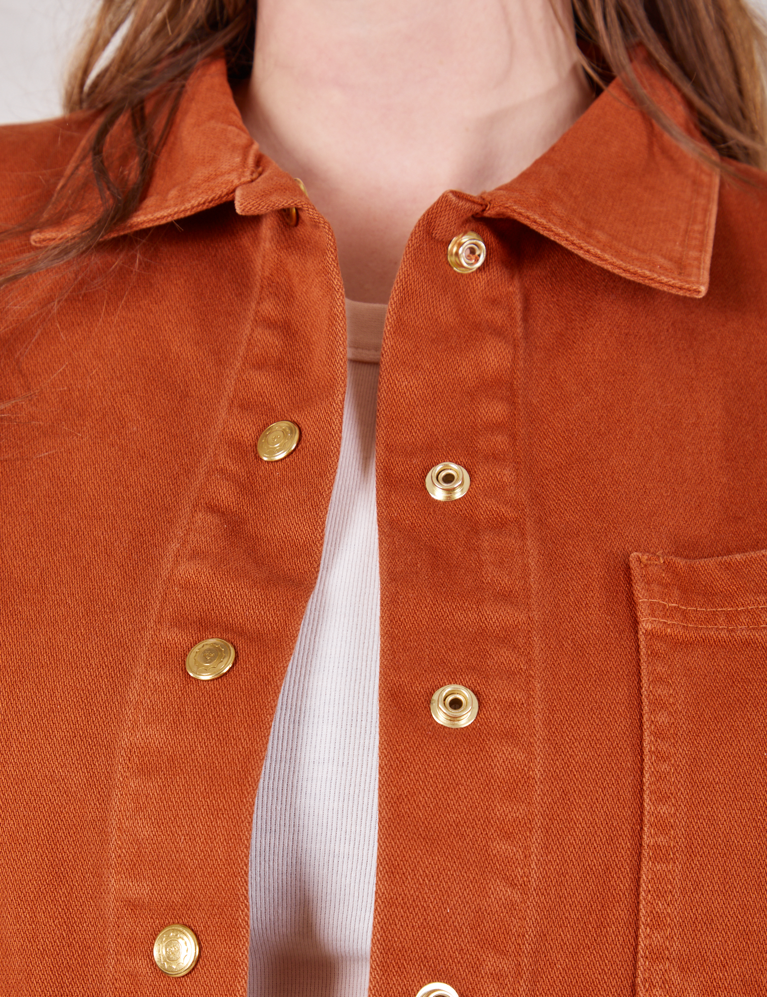 Denim Work Jacket in Burnt Terracotta front close up showing custom sun baby brass snaps