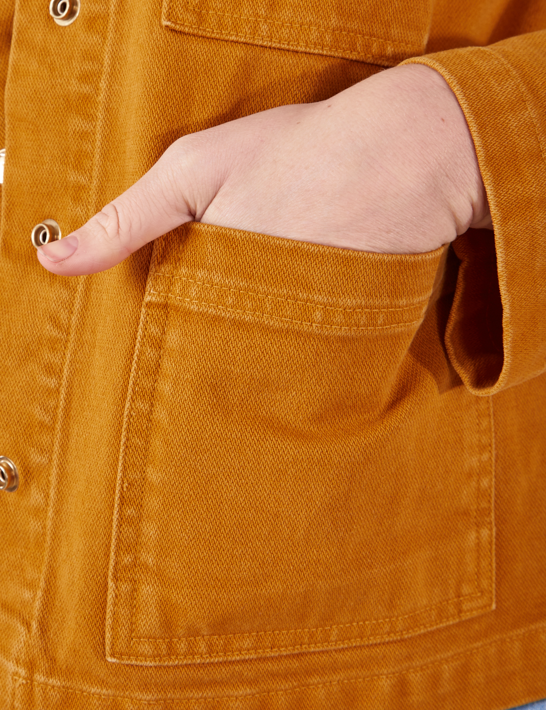 Denim Work Jacket in Spicy Mustard hand in bottom front pocket close up