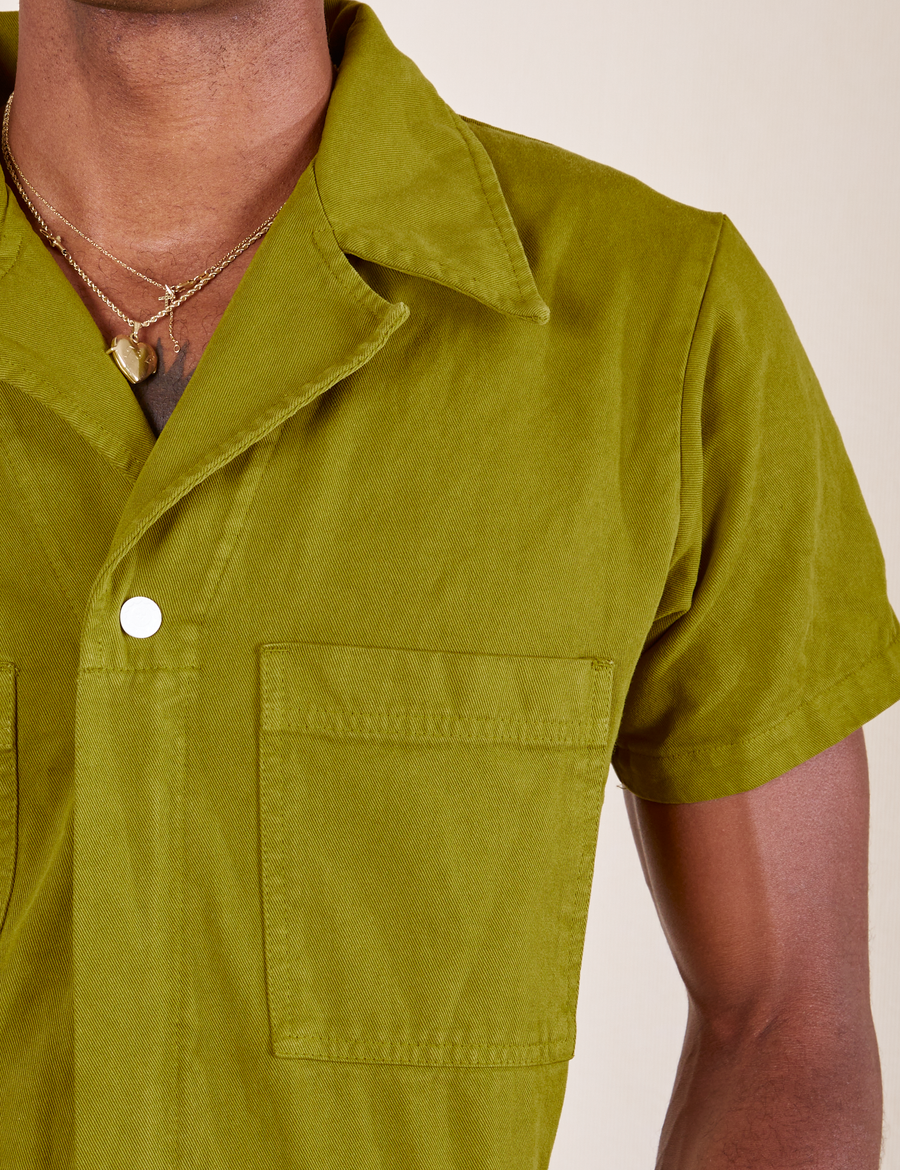 Short Sleeve Jumpsuit in Olive Green front pocket and collar close up on Jerrod